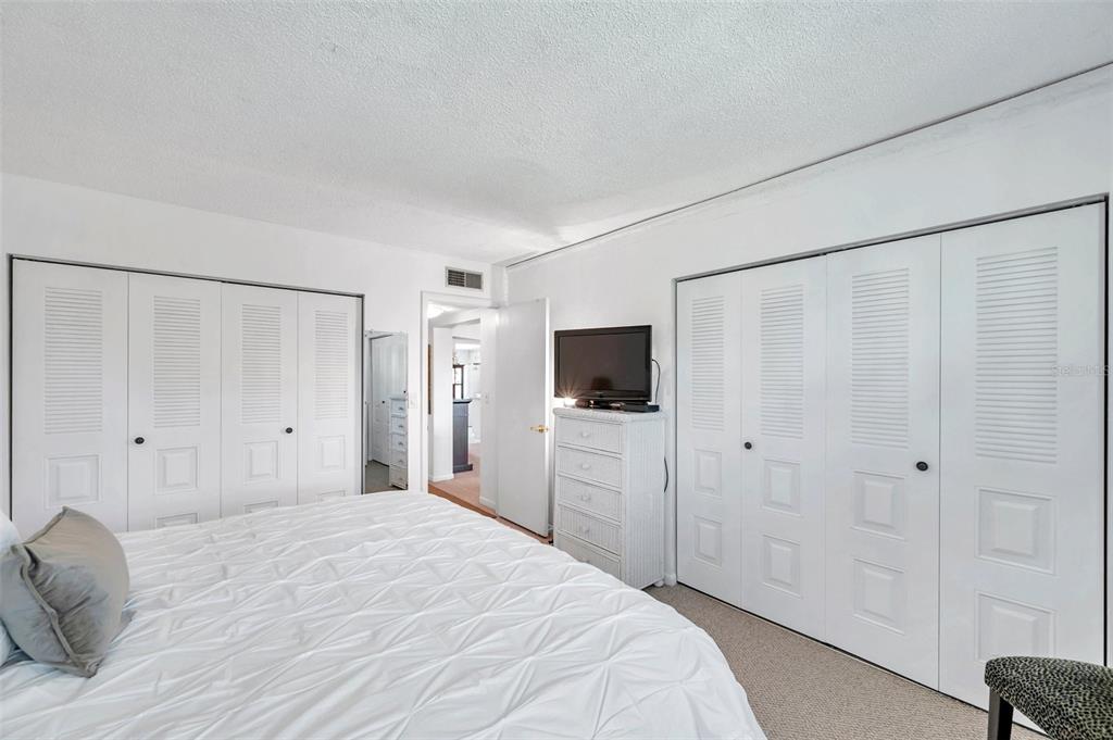 1430 Heather Ridge Boulevard, Unit 304 Dunedin, FL 34698 - Photo 18 of 36 a bedroom with a bed and a flat screen tv