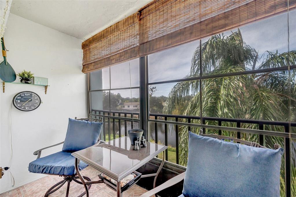 1430 Heather Ridge Boulevard, Unit 304 Dunedin, FL 34698 - Photo 22 of 36 a view of a chairs and table in the balcony