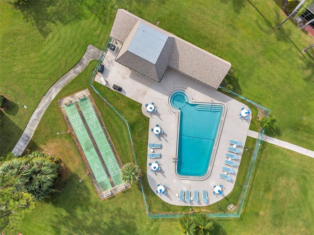 1430 Heather Ridge Boulevard, Unit 304 Dunedin, FL 34698 - Photo 24 of 36 an aerial view of a swimming pool