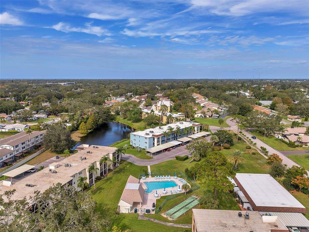 1430 Heather Ridge Boulevard, Unit 304 Dunedin, FL 34698 - Photo 25 of 36 an aerial view of residential houses with outdoor space