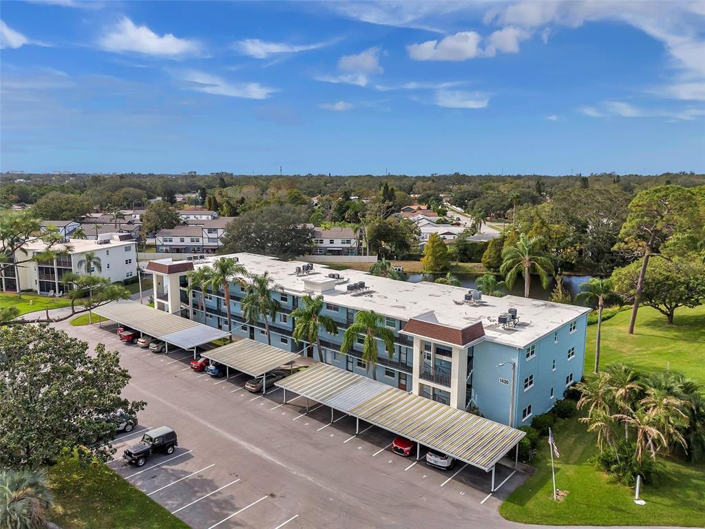 1430 Heather Ridge Boulevard, Unit 304 Dunedin, FL 34698 - Photo 27 of 36 an aerial view of residential houses with outdoor space and trees