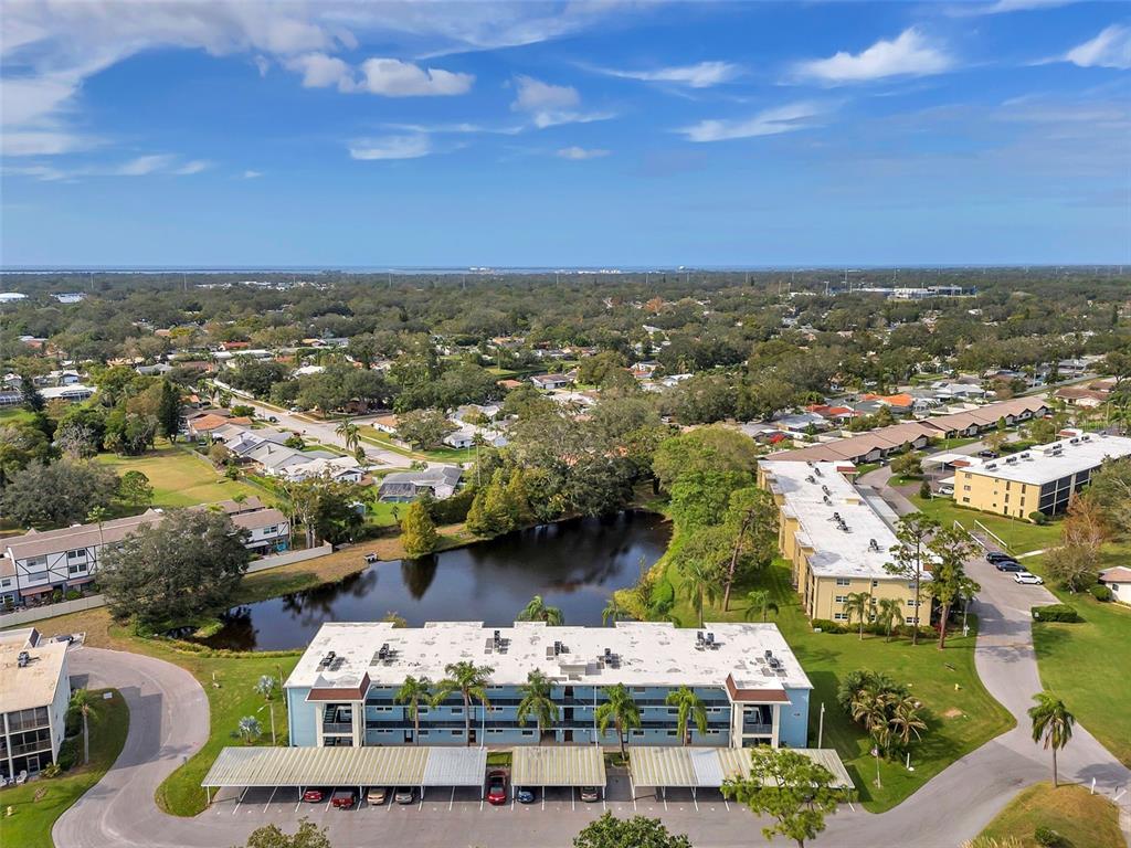 1430 Heather Ridge Boulevard, Unit 304 Dunedin, FL 34698 - Photo 28 of 36 an aerial view of residential houses with outdoor space