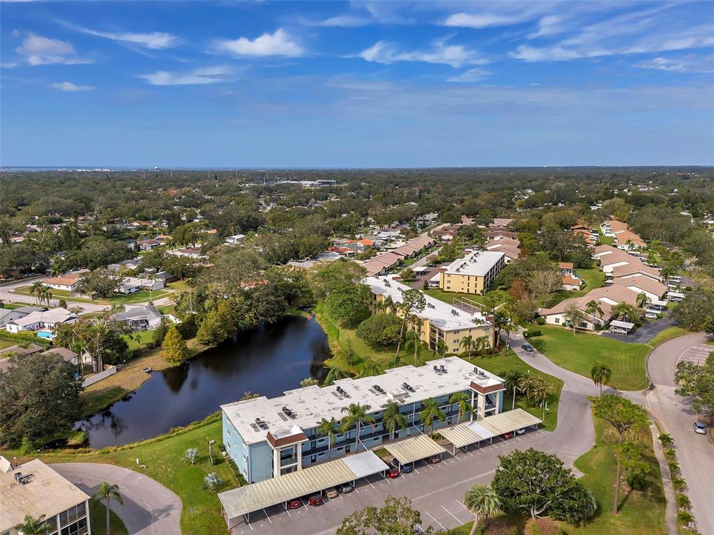 1430 Heather Ridge Boulevard, Unit 304 Dunedin, FL 34698 - Photo 29 of 36 an aerial view of residential houses with outdoor space