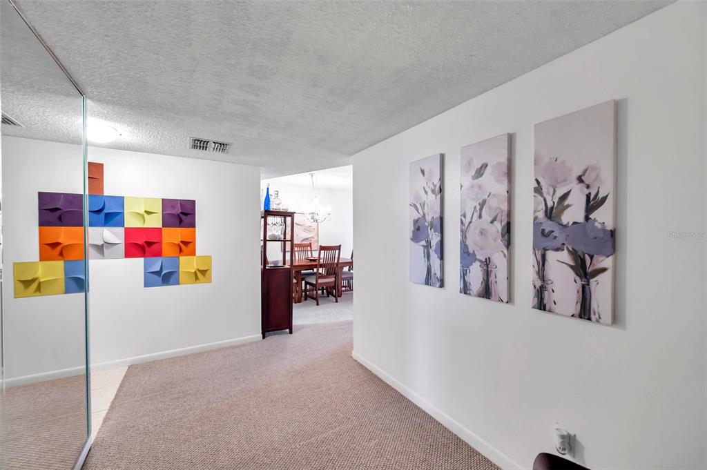 1430 Heather Ridge Boulevard, Unit 304 Dunedin, FL 34698 - Photo 4 of 36 a view of a livingroom with furniture and garage