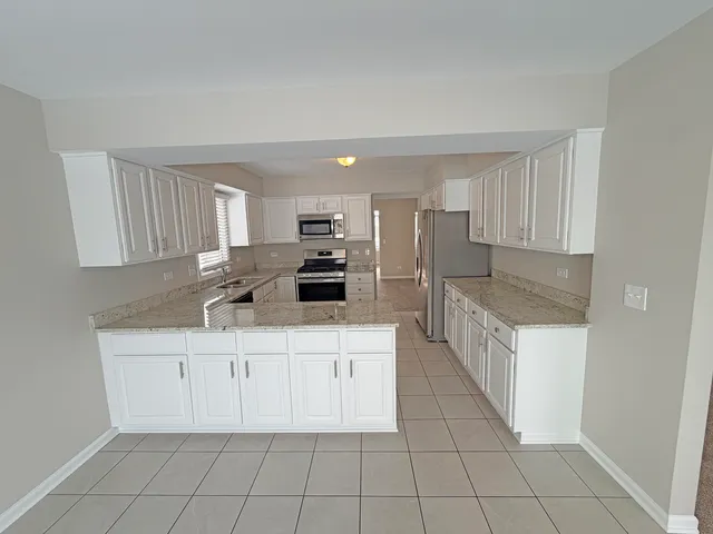a kitchen with stainless steel appliances a sink stove and cabinets