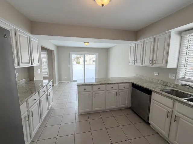 a large kitchen with a stove a sink dishwasher and a refrigerator