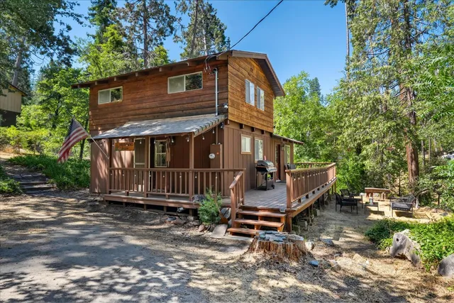 a view of a house with a yard and wooden fence