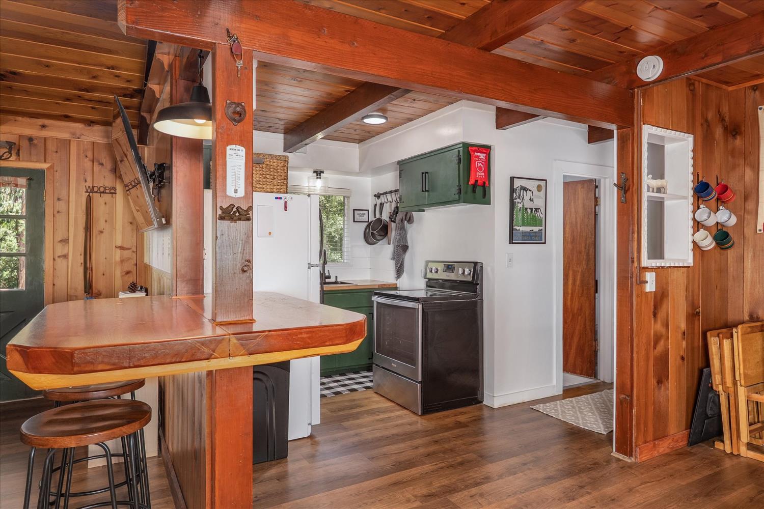 44800 Mountain Meadow Road Oakhurst, CA 93644 - Photo 11 of 41 a room with stainless steel appliances kitchen island granite countertop a table chairs and a refrigerator
