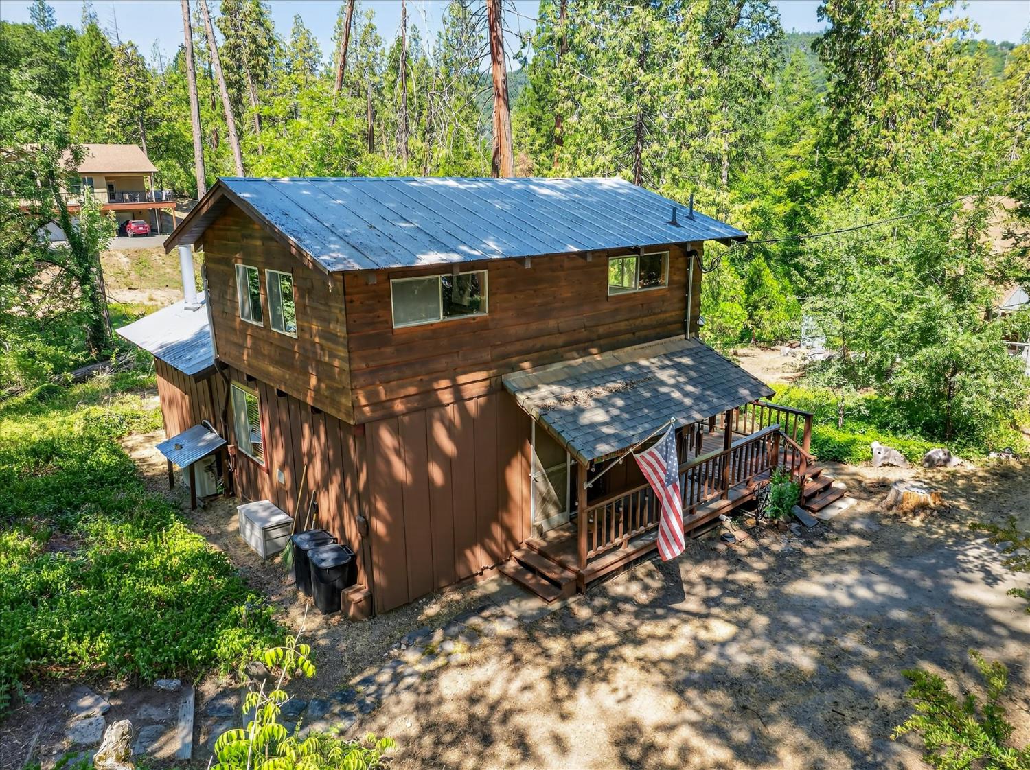 44800 Mountain Meadow Road Oakhurst, CA 93644 - Photo 2 of 41 a view of a wooden house with a yard