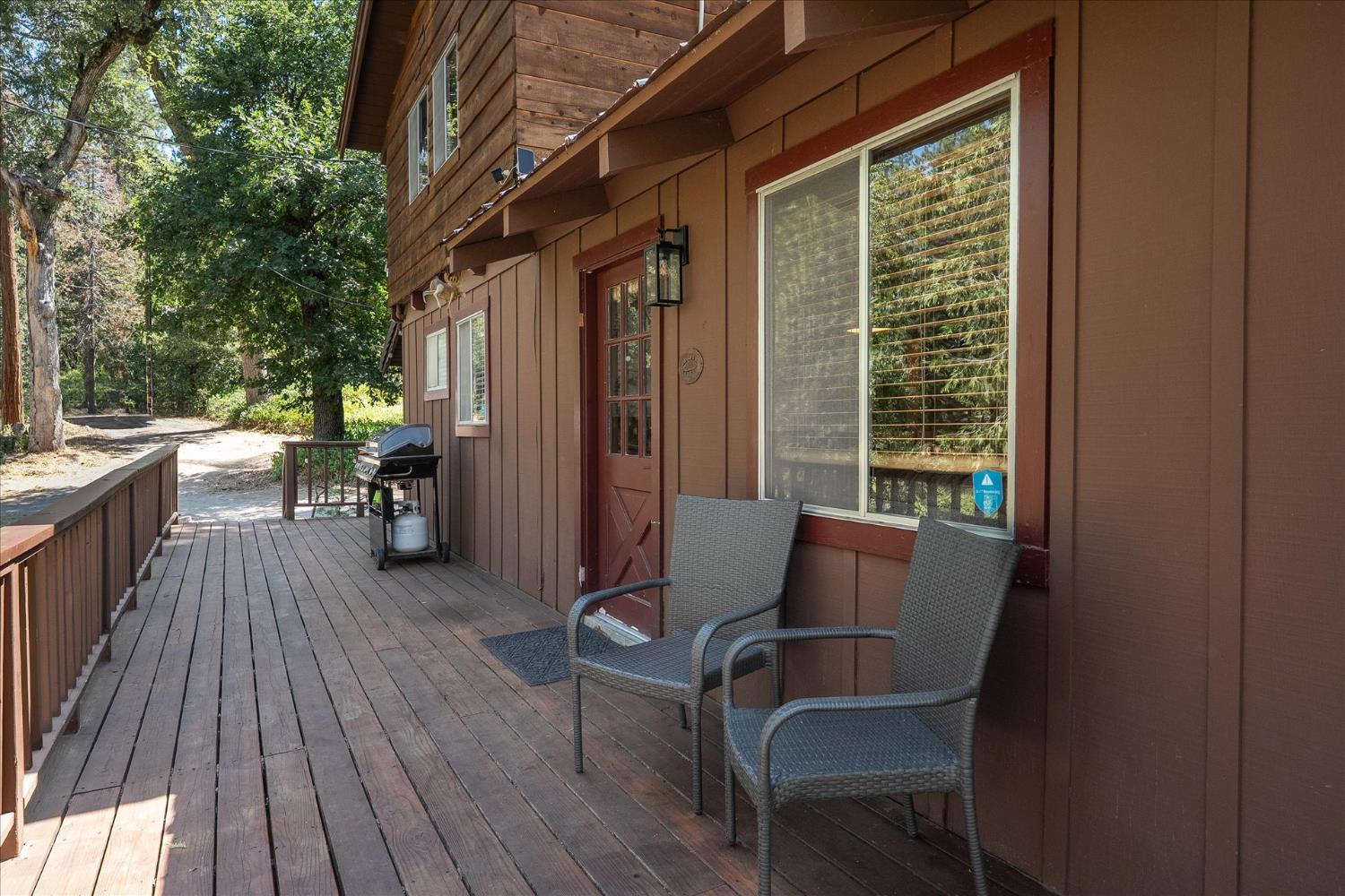 44800 Mountain Meadow Road Oakhurst, CA 93644 - Photo 25 of 41 a view of a house with backyard and sitting area
