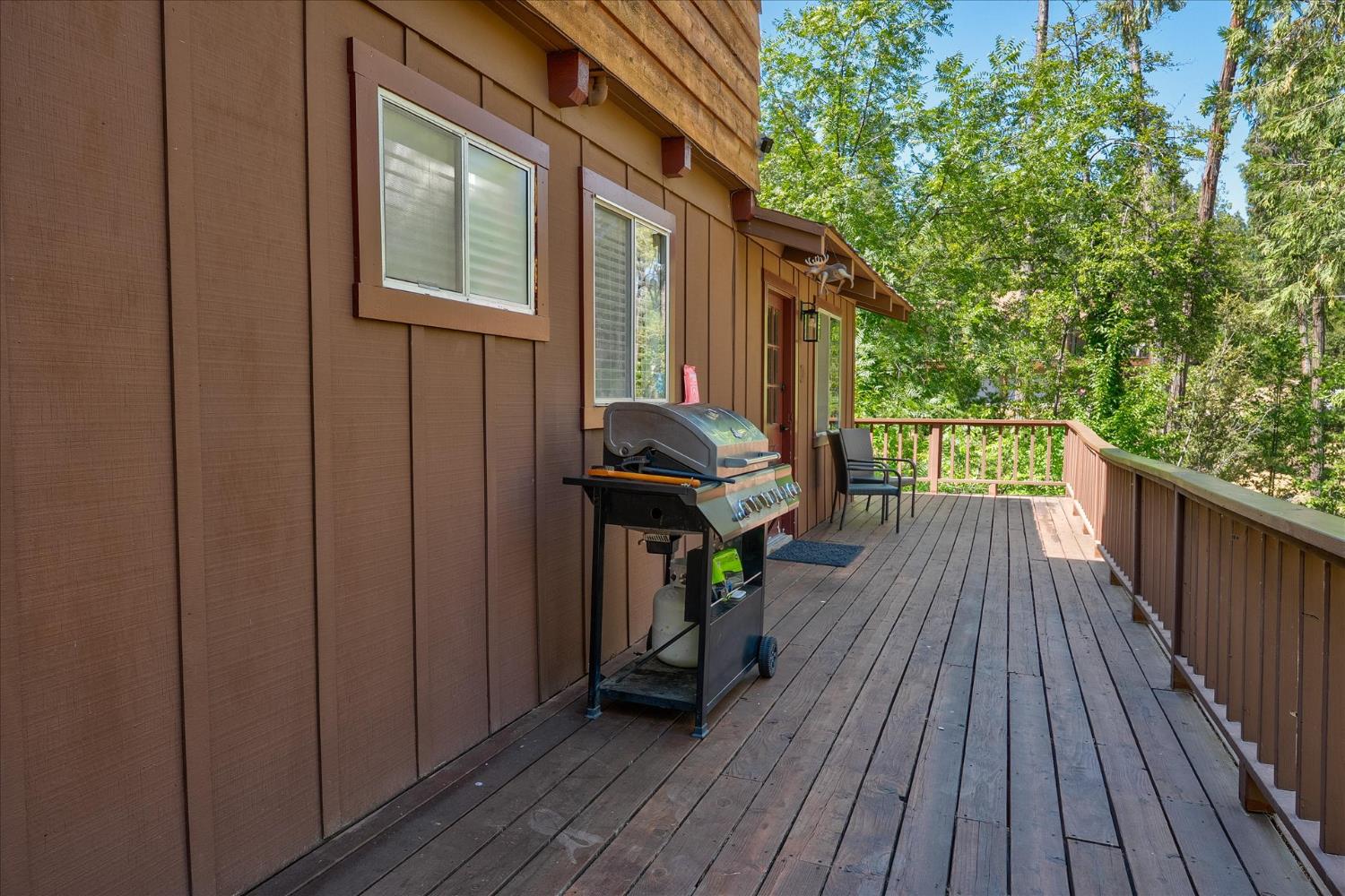 44800 Mountain Meadow Road Oakhurst, CA 93644 - Photo 28 of 41 a view of a deck with wooden floor and outdoor space