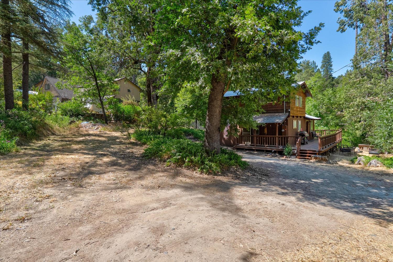 44800 Mountain Meadow Road Oakhurst, CA 93644 - Photo 36 of 41 a view of a street with trees and a trees