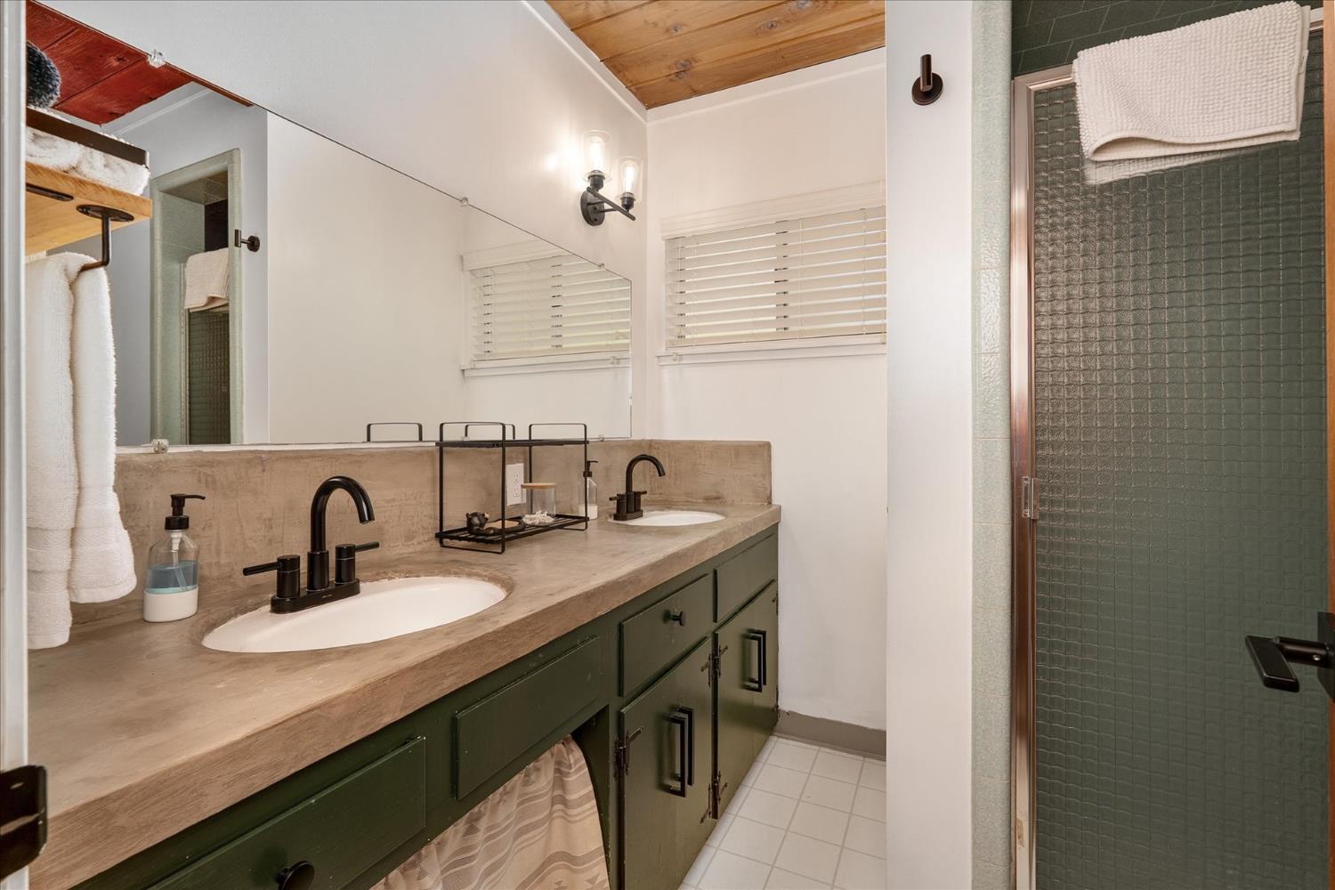 44800 Mountain Meadow Road Oakhurst, CA 93644 - Photo 9 of 41 a bathroom with a granite countertop sink a large mirror and vanity