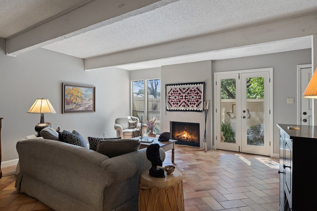 3500 Enfield Road, Unit E Austin, TX 78703 - Photo 8 of 40 The fireplace offers a cozy, charming centerpiece, flanked by full size windows and doors.