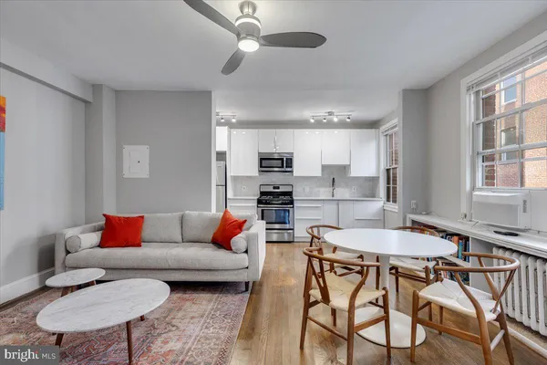 a living room with furniture and kitchen view