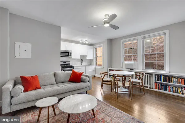 a living room with furniture fireplace and a window