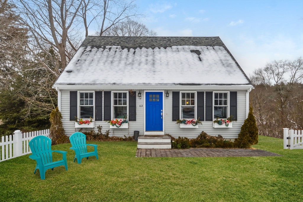 a view of a house with a yard and sitting area