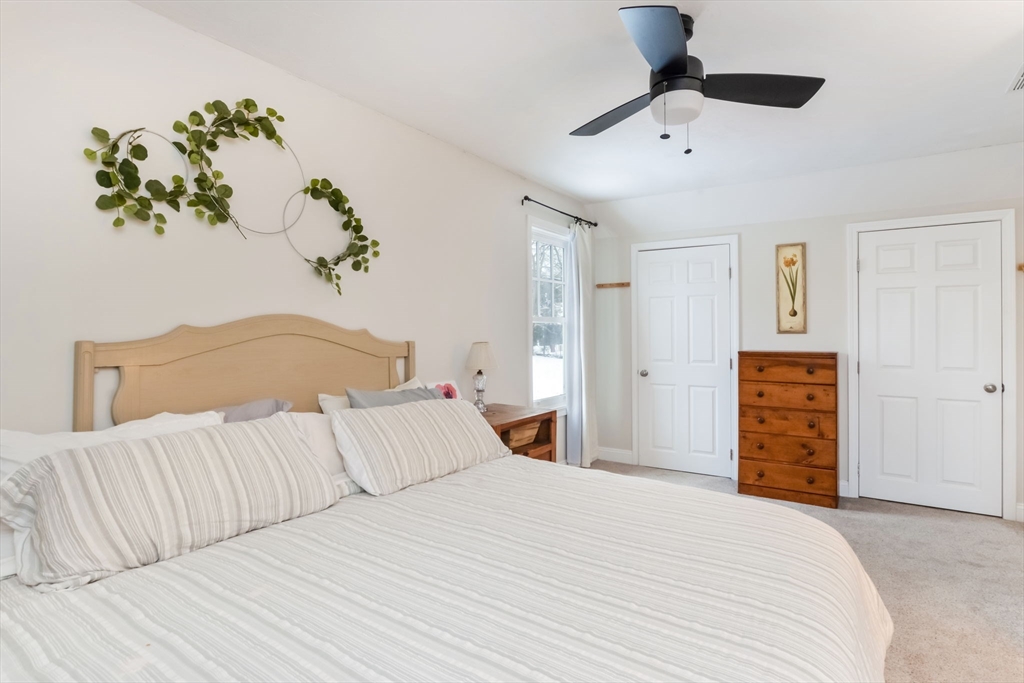 63 Wareham Street Middleboro, MA 02346 - Photo 13 of 23 a bedroom with a bed and a chandelier