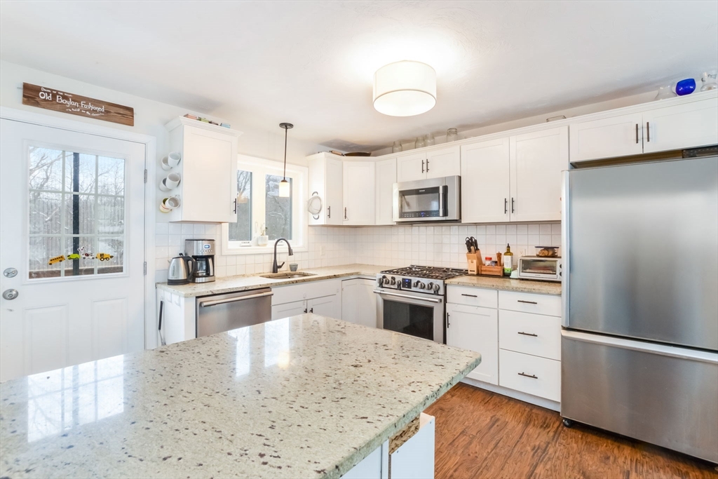 63 Wareham Street Middleboro, MA 02346 - Photo 7 of 23 a kitchen with stainless steel appliances granite countertop a refrigerator a stove top oven a sink and dishwasher