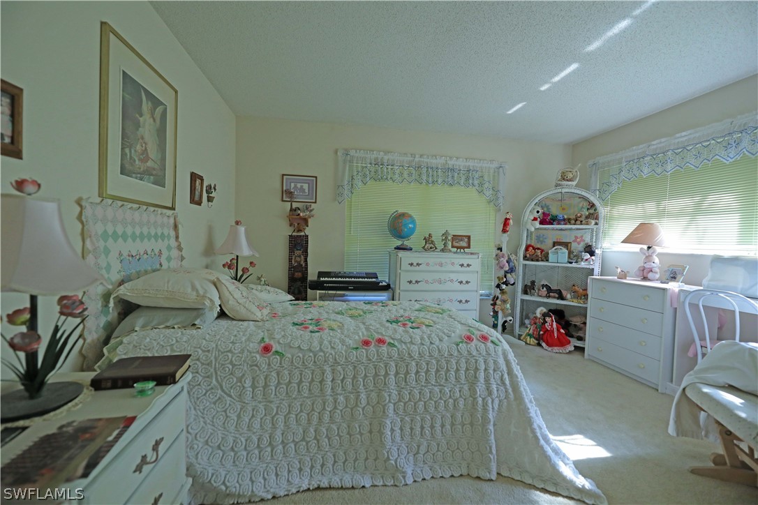 14430 Cemetery Road Fort Myers, FL 33905 - Photo 22 of 35 a kids bedroom with a bed a couch and dresser