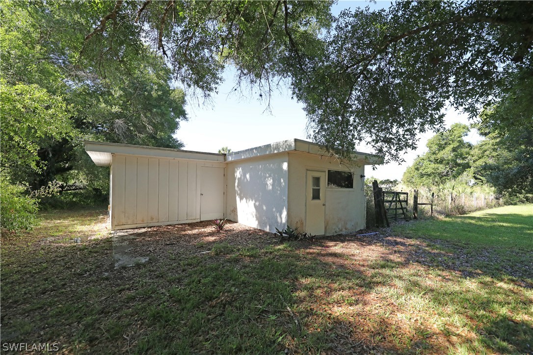 14430 Cemetery Road Fort Myers, FL 33905 - Photo 31 of 35 a view of a house with a yard and tree