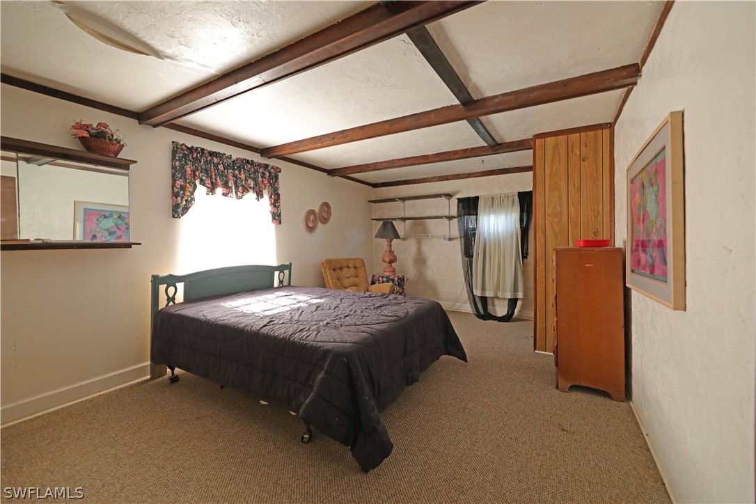 14430 Cemetery Road Fort Myers, FL 33905 - Photo 33 of 35 a bedroom with a bed and large mirror