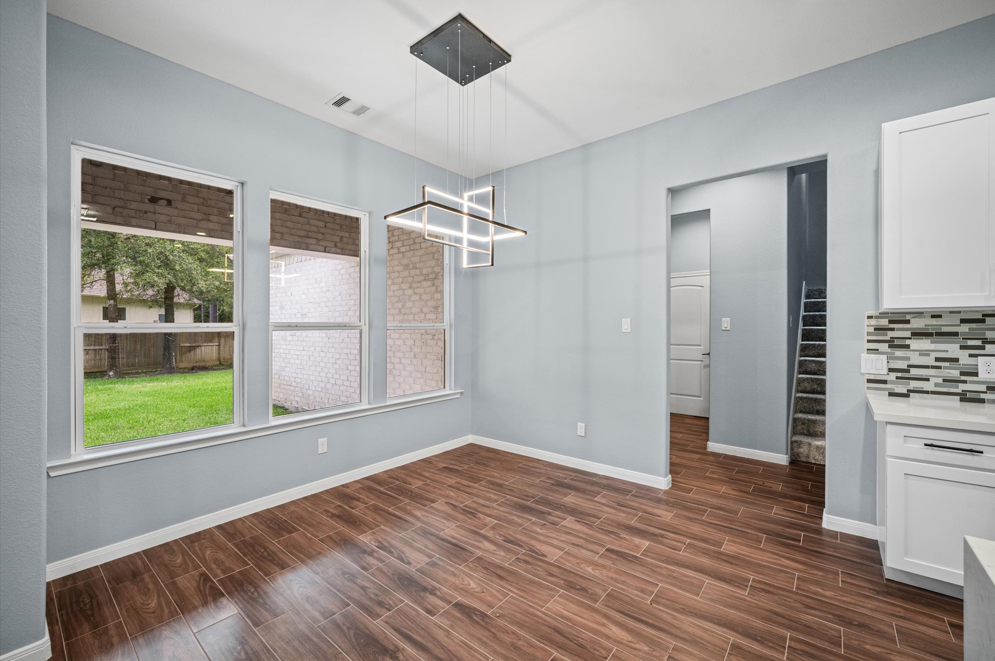 7 Pilot Point Conroe, TX 77304 - Photo 9 of 47 a view of an empty room with a window and wooden floor