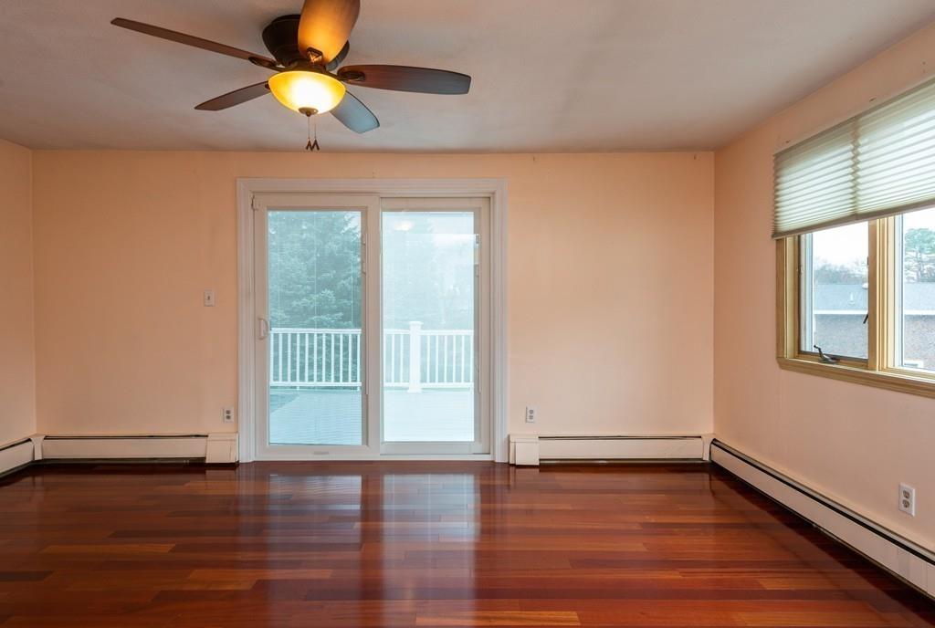 26 Doane Road Medford, MA 02155 - Photo 18 of 24 a view of an empty room with window and wooden floor