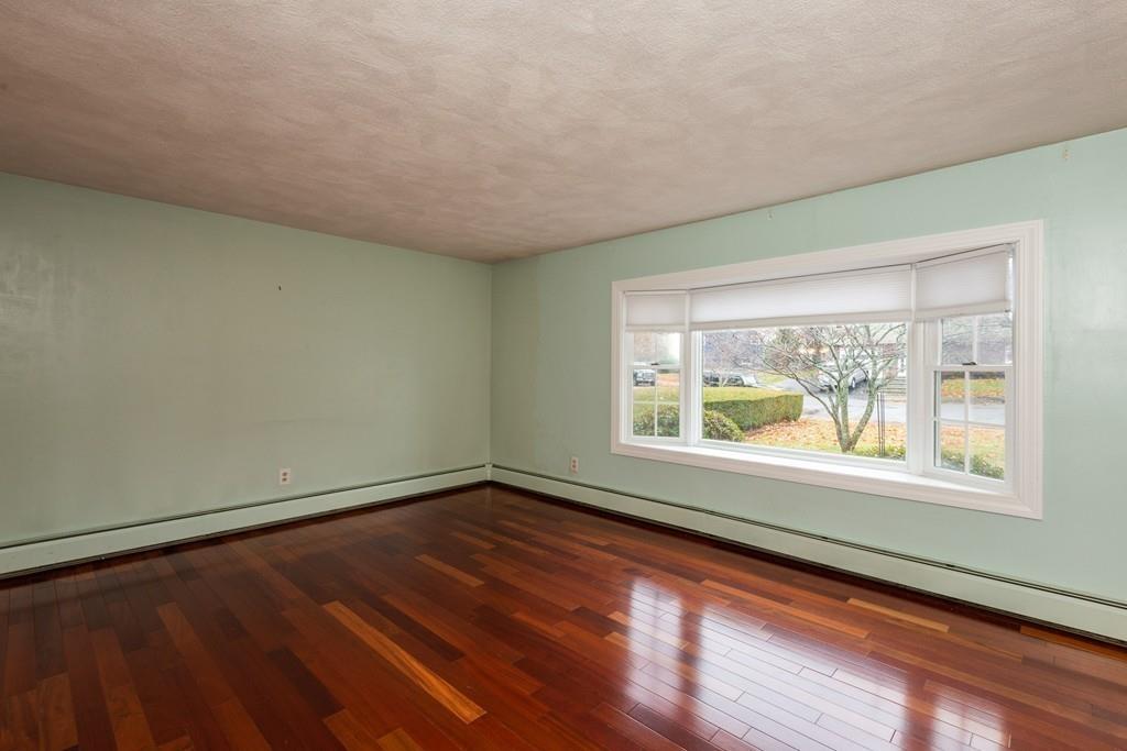 26 Doane Road Medford, MA 02155 - Photo 10 of 24 an empty room with wooden floor and windows