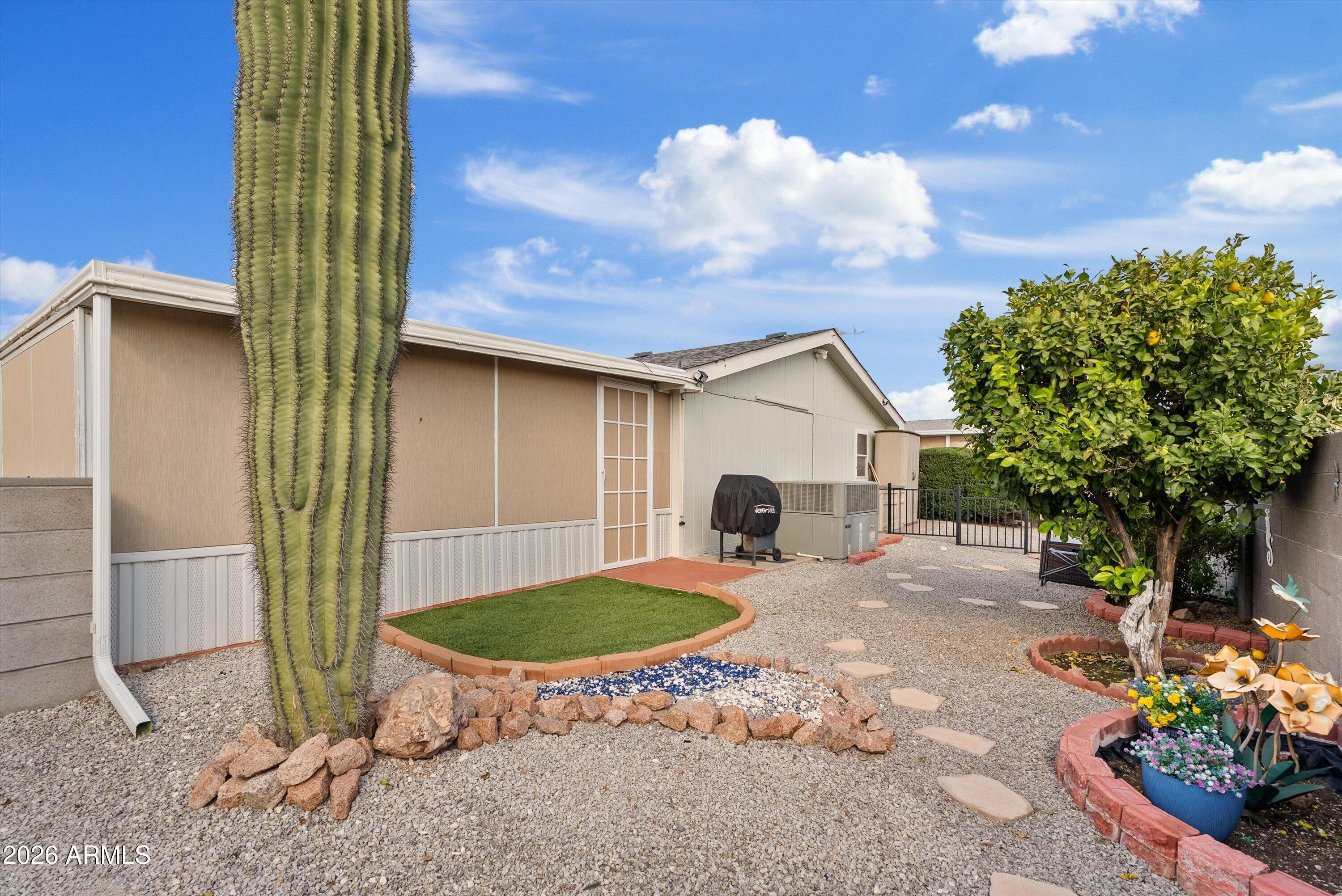 3700 South Tomahawk Road, Unit 91 Apache Junction, AZ 85119 - Photo 22 of 29 a view of a house with backyard and sitting area