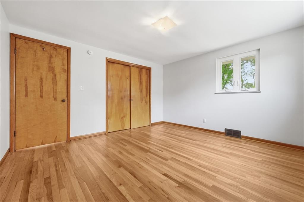6 Greenview Drive McKees Rocks, PA 15136 - Photo 16 of 44 a view of an empty room with wooden floor and a window
