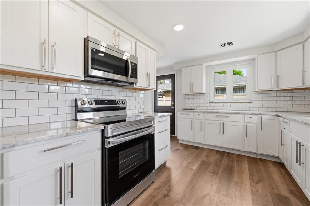 6 Greenview Drive McKees Rocks, PA 15136 - Photo 24 of 44 a kitchen with stainless steel appliances white cabinets a sink and a stove