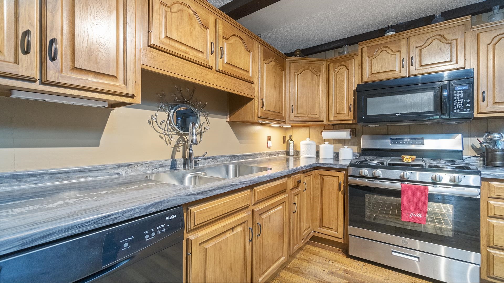 10289 Flory Road Lanark, IL 61046 - Photo 9 of 45 a kitchen with stainless steel appliances granite countertop a sink stove and microwave