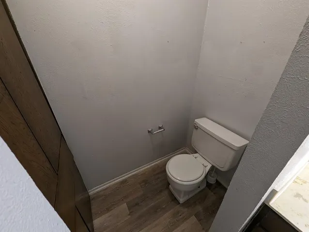 a white toilet sitting next to a sink