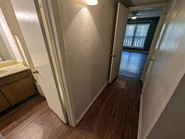 a view of a hallway and wooden floor