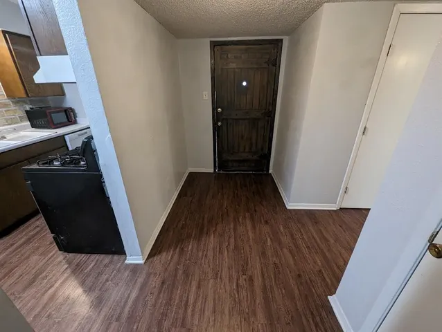 a view of a kitchen from a hallway