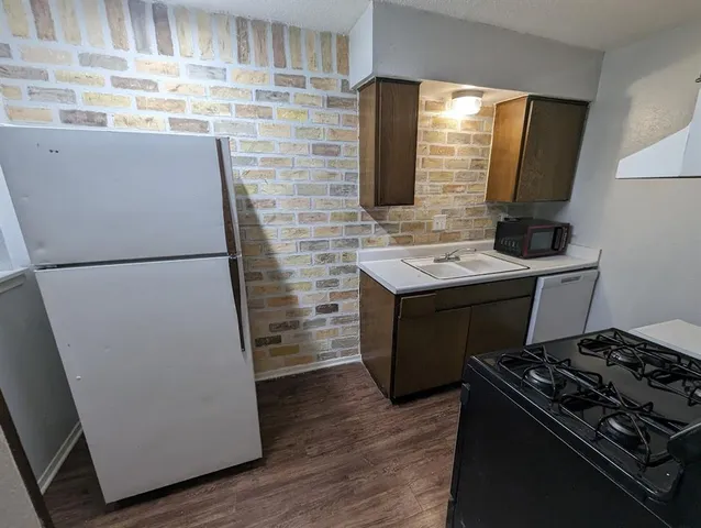 a kitchen with a stove and a refrigerator