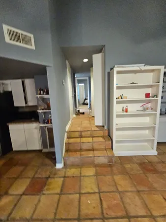 a view of a hallway with storage and utility