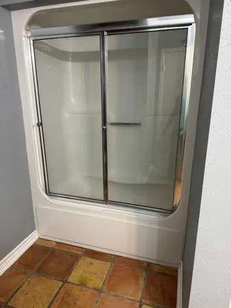 a bathroom with a glass shower door