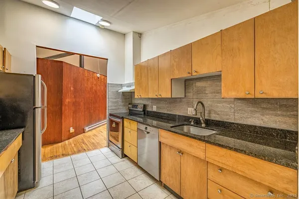 a kitchen with stainless steel appliances a sink stove and cabinets
