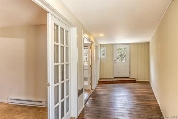 a view of hallway with wooden floor