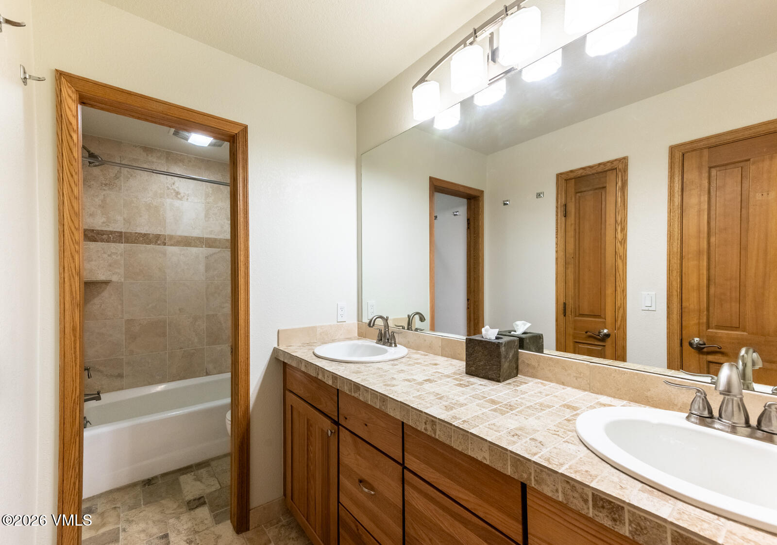 3016 Wildridge Road, Unit 6 Avon, CO 81620 - Photo 29 of 37 a bathroom with a tub a sink and a mirror