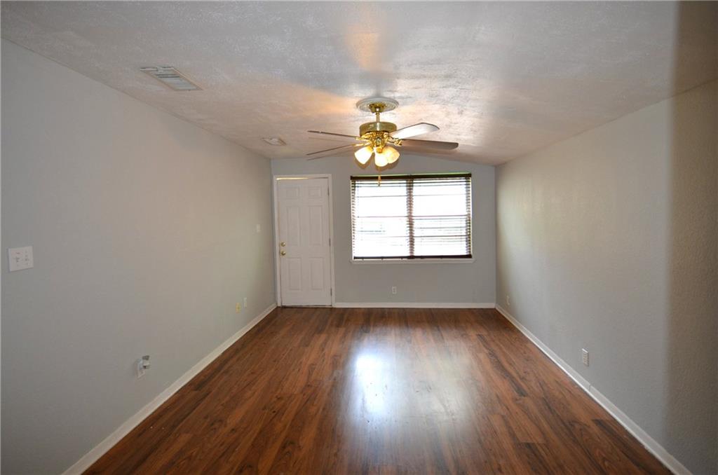 2016 East Cherry Street Sherman, TX 75090 - Photo 11 of 15 an empty room with wooden floor and window