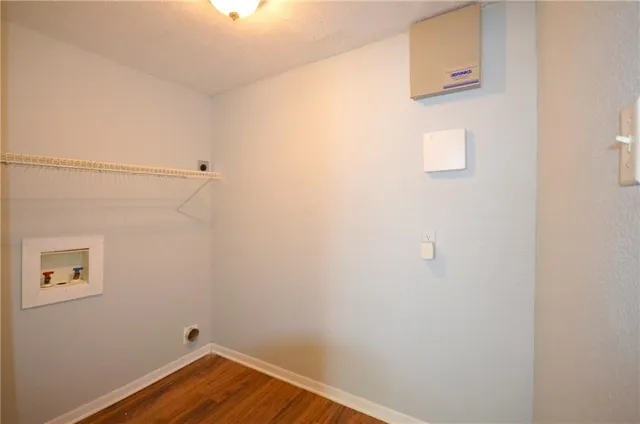 a view of a small space with wooden floor and a window