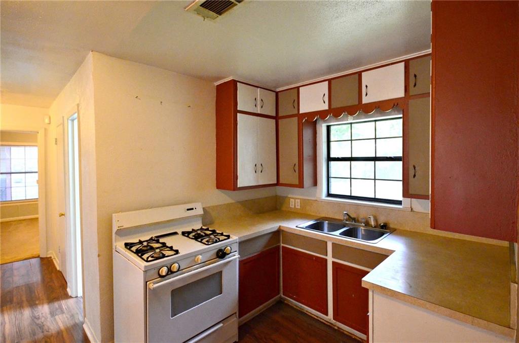 2016 East Cherry Street Sherman, TX 75090 - Photo 3 of 15 a kitchen that has a sink and a stove in it