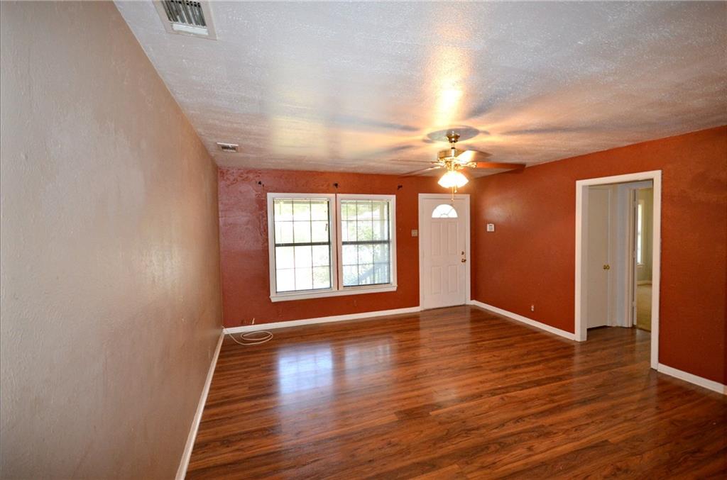 2016 East Cherry Street Sherman, TX 75090 - Photo 6 of 15 a view of an empty room with wooden floor and a window