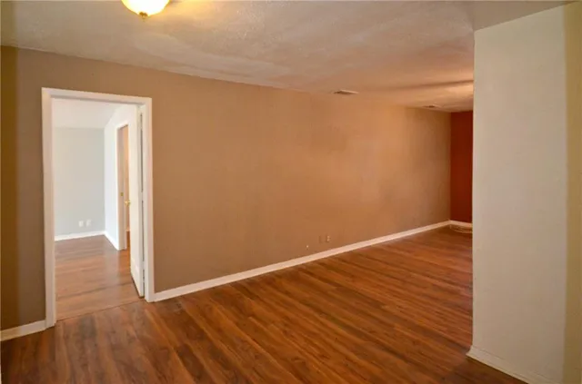 a view of a room with wooden floor