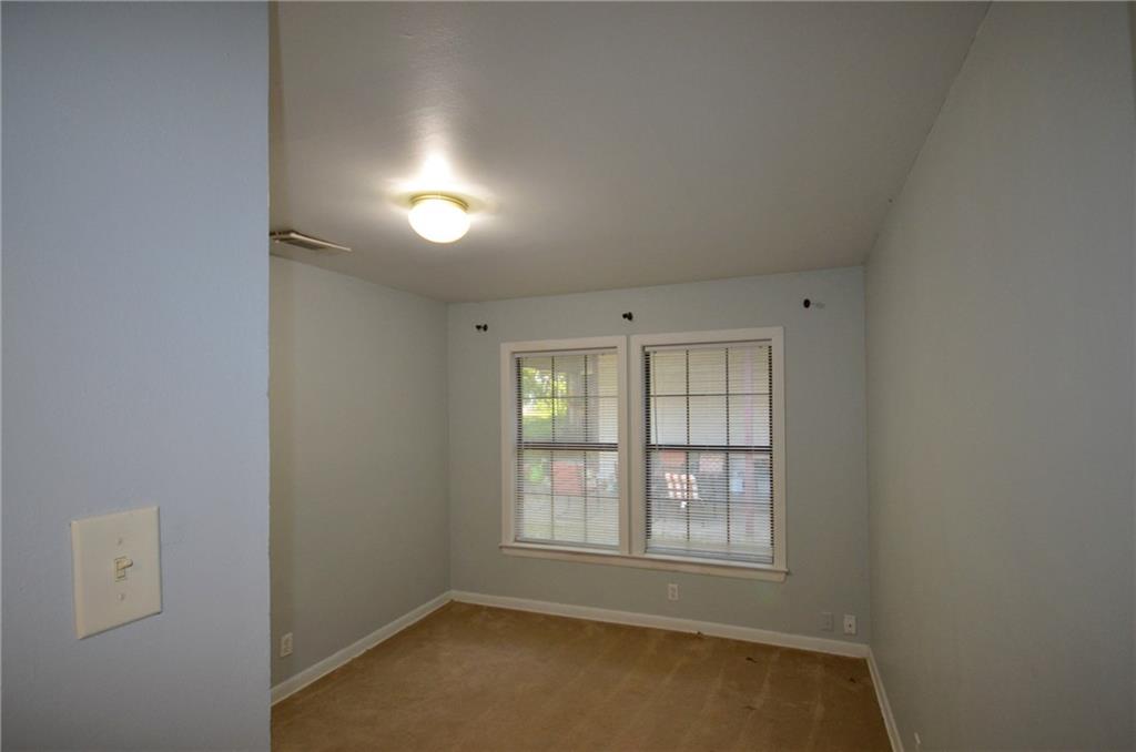 2016 East Cherry Street Sherman, TX 75090 - Photo 10 of 15 an empty room with chandelier fan and windows