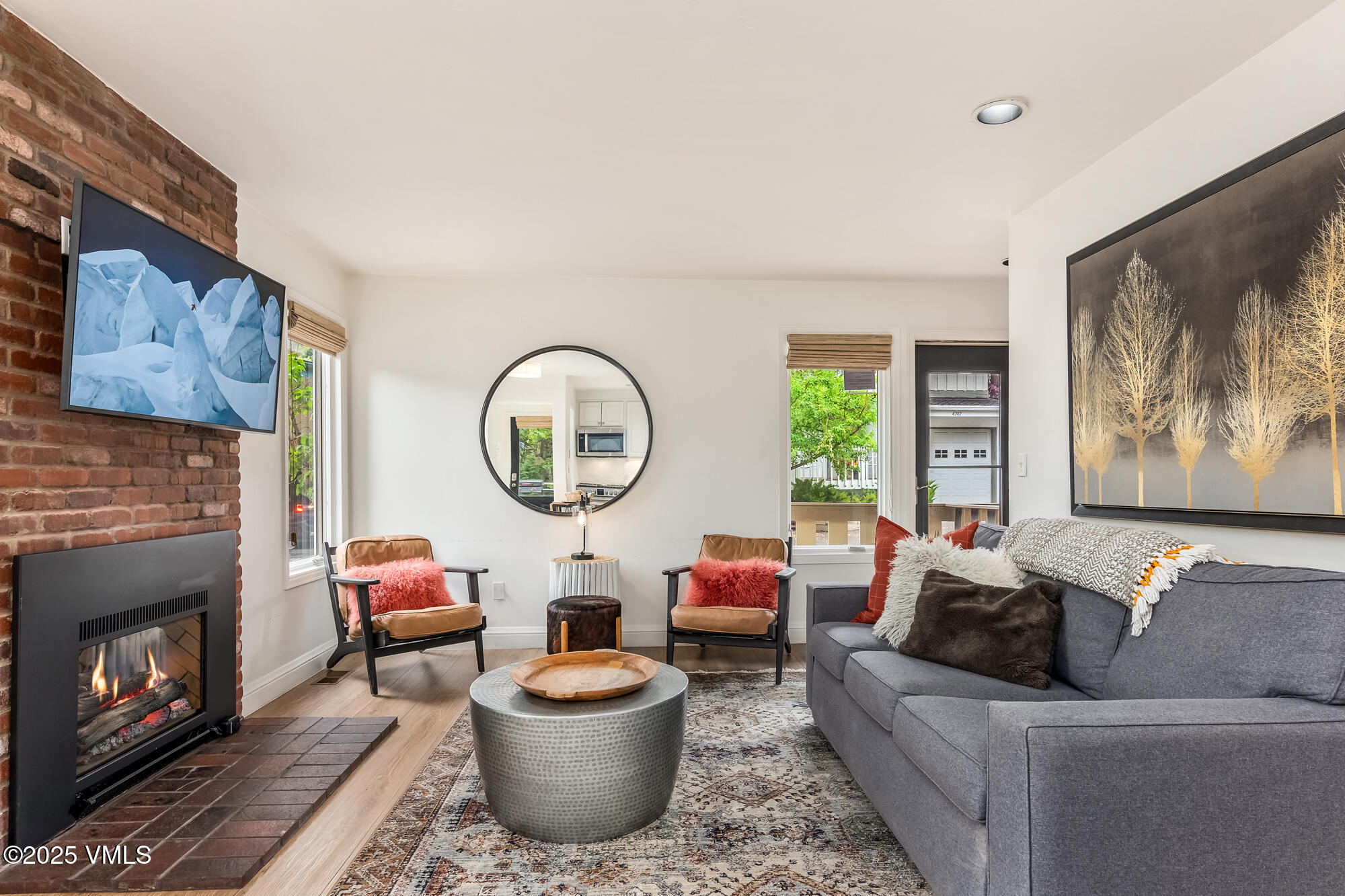 a living room with furniture a window and a fireplace
