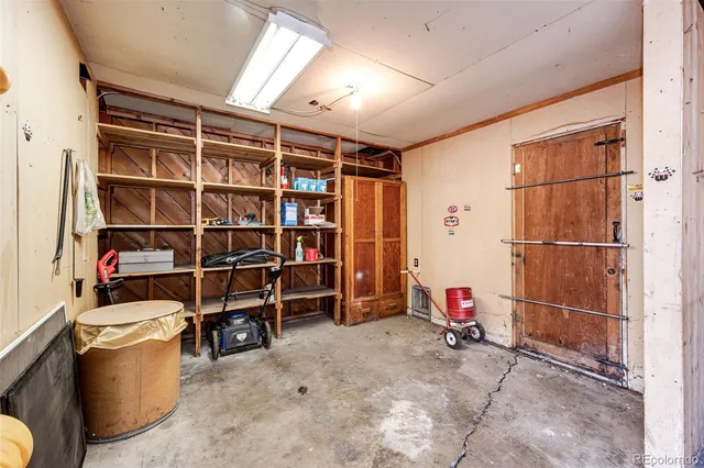 a view of room with wooden shelves and empty racks